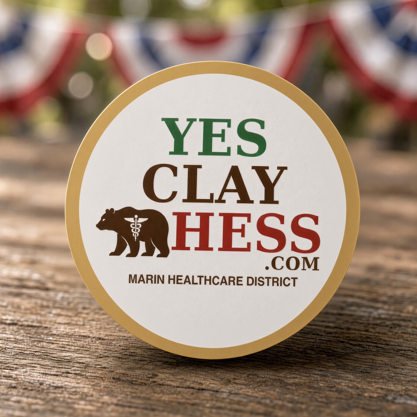 Outdoor YES CLAY HESS.com sticker with bear and caduceus on a vehicle